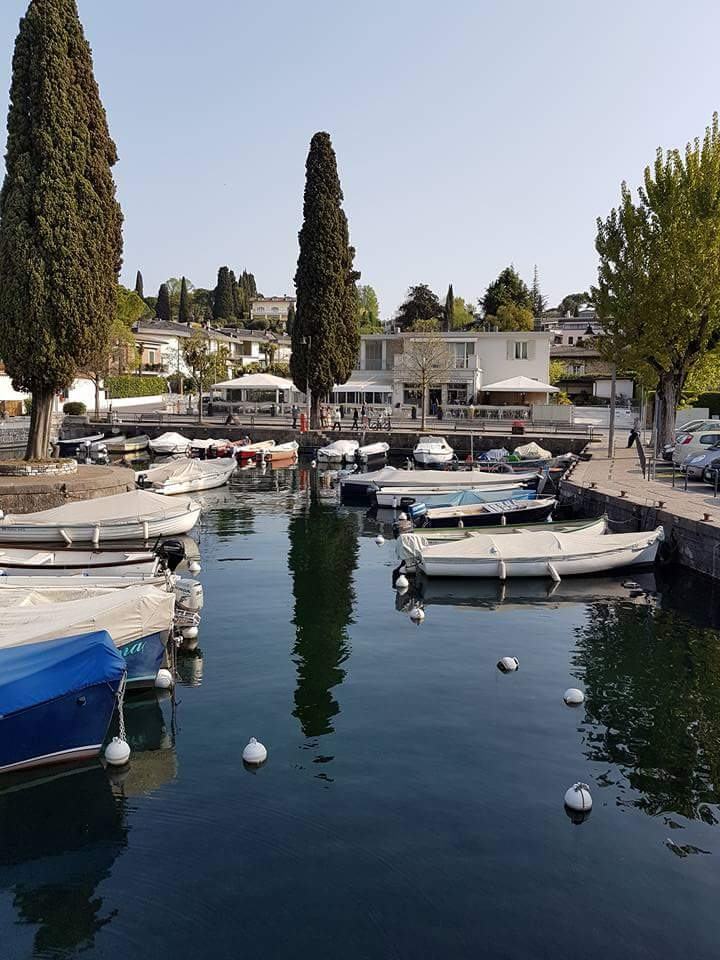The restaurant seen from the far side of the harbour at Portese, among the cypresses.